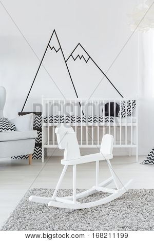 Cockhorse in baby room with scandinavian crib