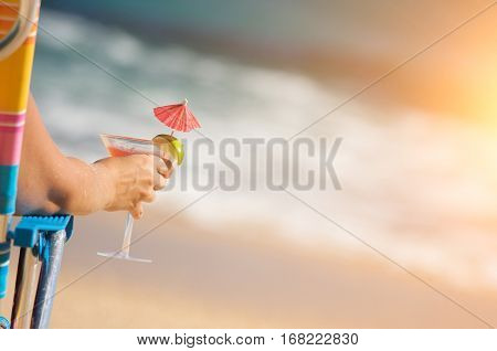 Woman Relaxing on Beach with Tropical Drink.