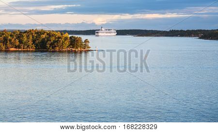 view of cruise liner and coastline of Baltic Sea in autumn sunset Sweden