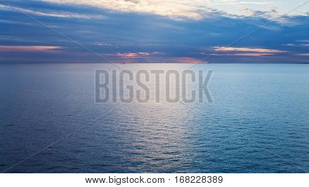 pink sunset over calm blue Baltic Sea in autumn evening