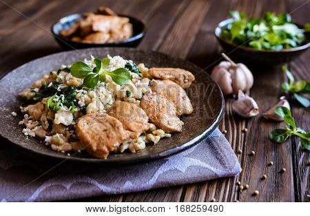 Fried Chicken Meat With Spelt Flour Dumplings And Spinach