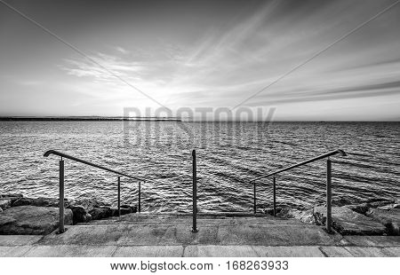 Steps On A Beach With Sunset On The Ocean Sea.