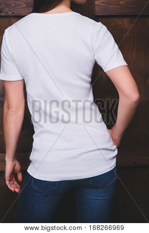 Young woman wearing blank white t-shirt with area for your logo or design, mock-up of template white t-shirt, back view