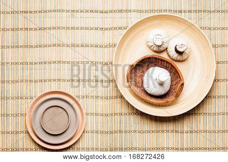 Massage bundles on a plate on bamboo mat. Spa, health, treatment, concept.