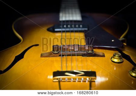 Jazz arch top guitar with a focus on the bridge