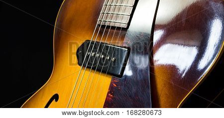 Jazz arch top guitar on a black background