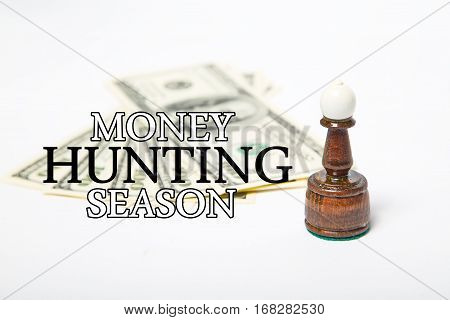 Chess Bishop Figure and dollars with message MONEY HUNTING  SEASON