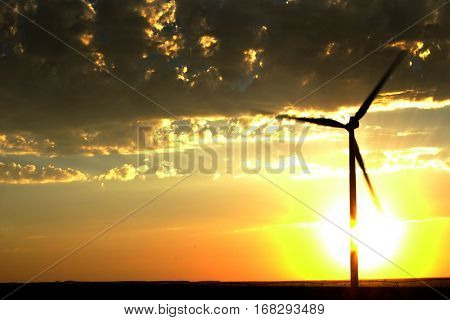 Power generated by wind with winmill blowing sky clouds sunset sunrise