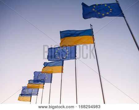 Ukrainian and European flags on blue sky. revolution