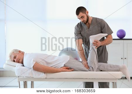 Physiotherapist working with patient in clinic