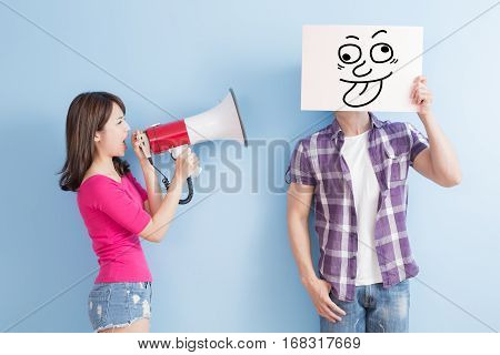 woman take the microphone shout to man angrily isolated on blue background