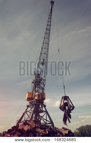 Crane With A Metal Claw Lifting Scrap