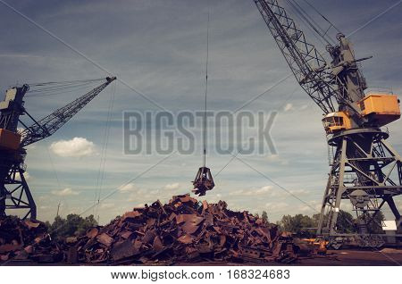 Metal Recycling Cranes Lifting Scrap From The Pile
