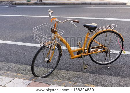 Yellow bicycle park at roadside in JAPAN.