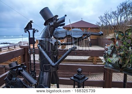 ZELENOGRADSK, KALININGRAD REGION, RUSSIA - January 26, 2017: Sculpture of iron stray dogs musicians which play a musical instrument in the popular russian sea resort Zelenogradsk (Cranz).