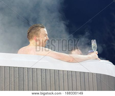 STOCKHOLM SWEDEN - JAN 31 2017: Man drinking champagne in a VIP hot tub at the Alpine Audi FIS Ski World Cup - city event January 31 2017 Stockholm Sweden