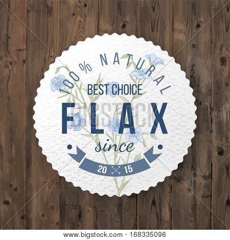 Round label with type design and hand drawn flax over wooden background