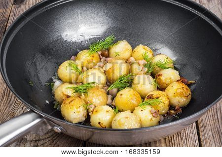 Fried potato dumplings with bacon in frying pan. Studio Photo