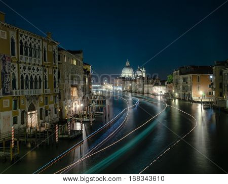 Grand canal in Venice during night  with water bus lighting the water