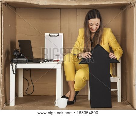 Business Woman Holds The Arrow Up Sign To Bounce Back From The Bottom