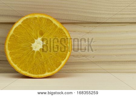cut fresh juicy natural sour orange on wooden background