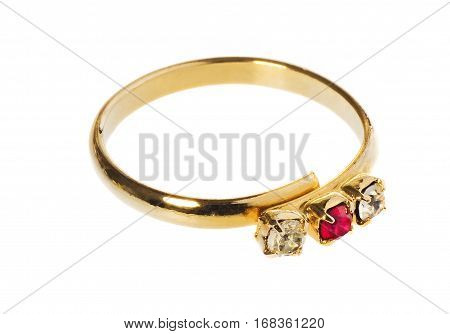 Gold ring with a ruby and two diamonds. Ring lies on a white background with a slight shadow and reflection.