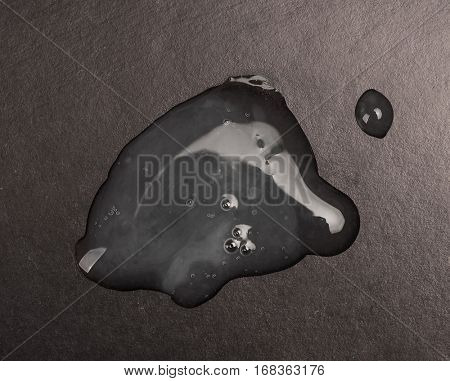 Real sperm puddle on black background