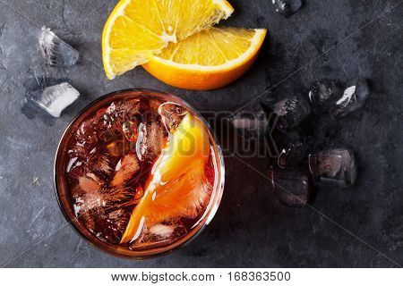 Negroni cocktail on dark stone table. Top view