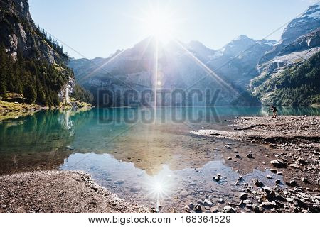 Panorama of the azure pond Oeschinensee. Popular tourist attraction. Picturesque and gorgeous scene. Location Swiss alps, Kandersteg, Bernese Oberland, Europe. Instagram toning effect. Beauty world.