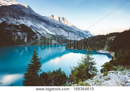 Glacier pond Oeschinensee. Popular tourist attraction. Picturesque and gorgeous scene. Location Swiss alps, Kandersteg, Bernese Oberland, Europe. Vintage effect. Instagram filtered. Beauty world.