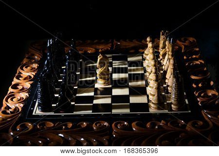 The chess pieces are placed on the chessboard. Defeated black king. The player admitted defeat