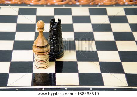 The chess pieces are placed on the chessboard. Defeated black king. The player admitted defeat