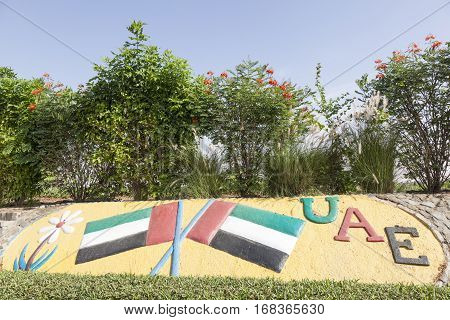 MEZAIRAA, UAE - DEC 4, 2016: UAE national flags monument in a roundabout in Liwa Oasis. Emirate of Abu Dhabi United Arab Emirates Middle East