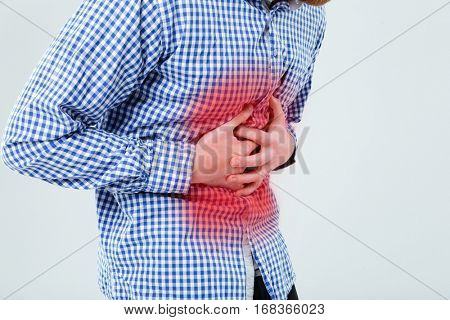 Cropped image of a man holding his hand on the stomach and feeling pain isolated on the white background