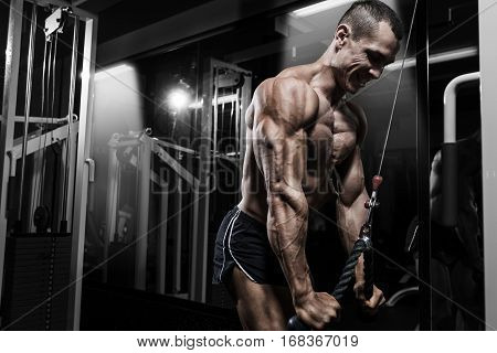 Athlete Muscular Bodybuilder Training Back On Simulator In The Gym