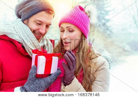couple opening outdoors present