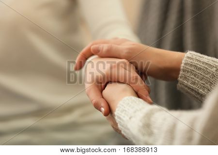 Hands of young woman countenancing depressed friend, closeup