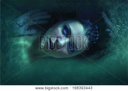 actress girl lies in green vodes volosamii flowing blue lips