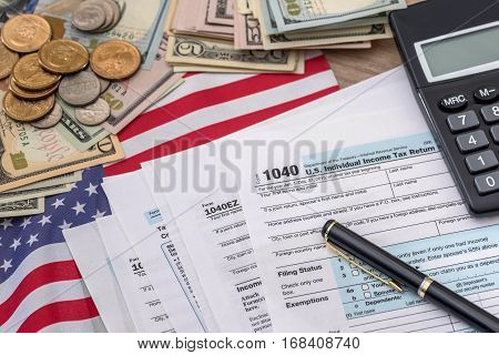 tax concept - 1040 tax form pen us money and flag