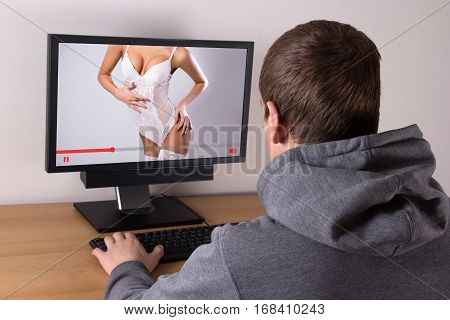 Young Man Watching Erotic Video With Sexy Woman