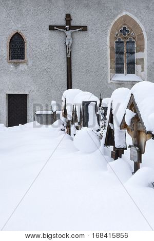 Cemetery And Church In Cold Winter Day With Snow Covered Graves