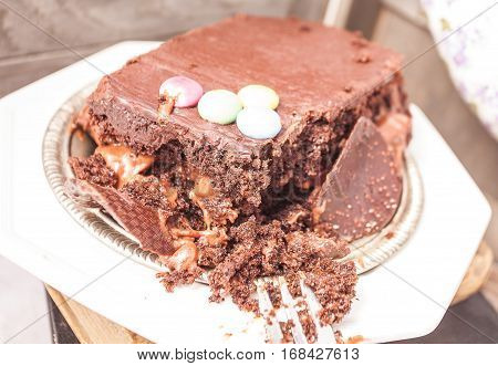 Slices of chocolate cake with strawberries. blueberries cream ganache hazelnut cream nuts cookies.