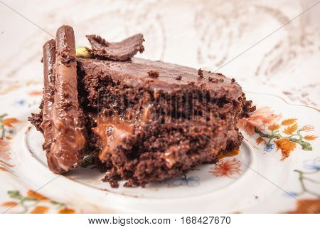 Slices of chocolate cake with strawberries. blueberries cream ganache hazelnut cream nuts cookies.
