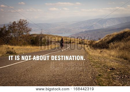 Lonely girl walking along the road in the mountains at sunset. Travel and freedom concept. It is not about destination. It is about the journey/ Inspirational Motivational Journey Quote Design.
