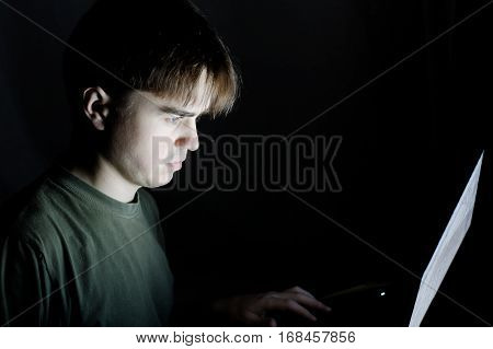 man in dark room using laptop young man working at computer fraud detection prevention concept serious programmer coding at night hacking,working, Internet addiction idea isolated dark background