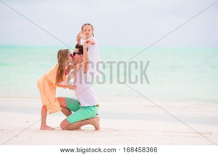 Happy beautiful family on a beach during summer vacation