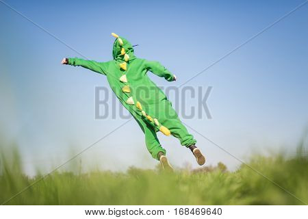Dragon kigurumi on the green fild, girl, portrait