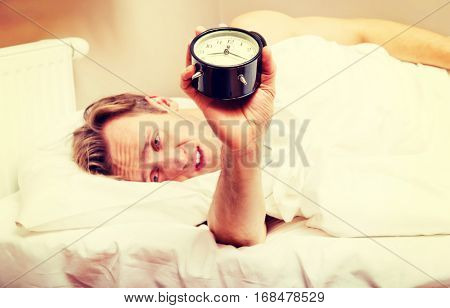 Man trying to sleep, when alarm clock ringing