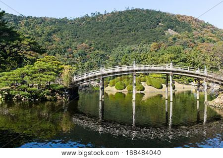 Japanese Ritsurin Garden and wooden bridge