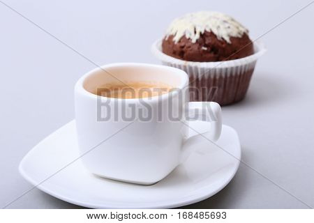 Classic style espresso shot with chip muffin and coffee beans on white background